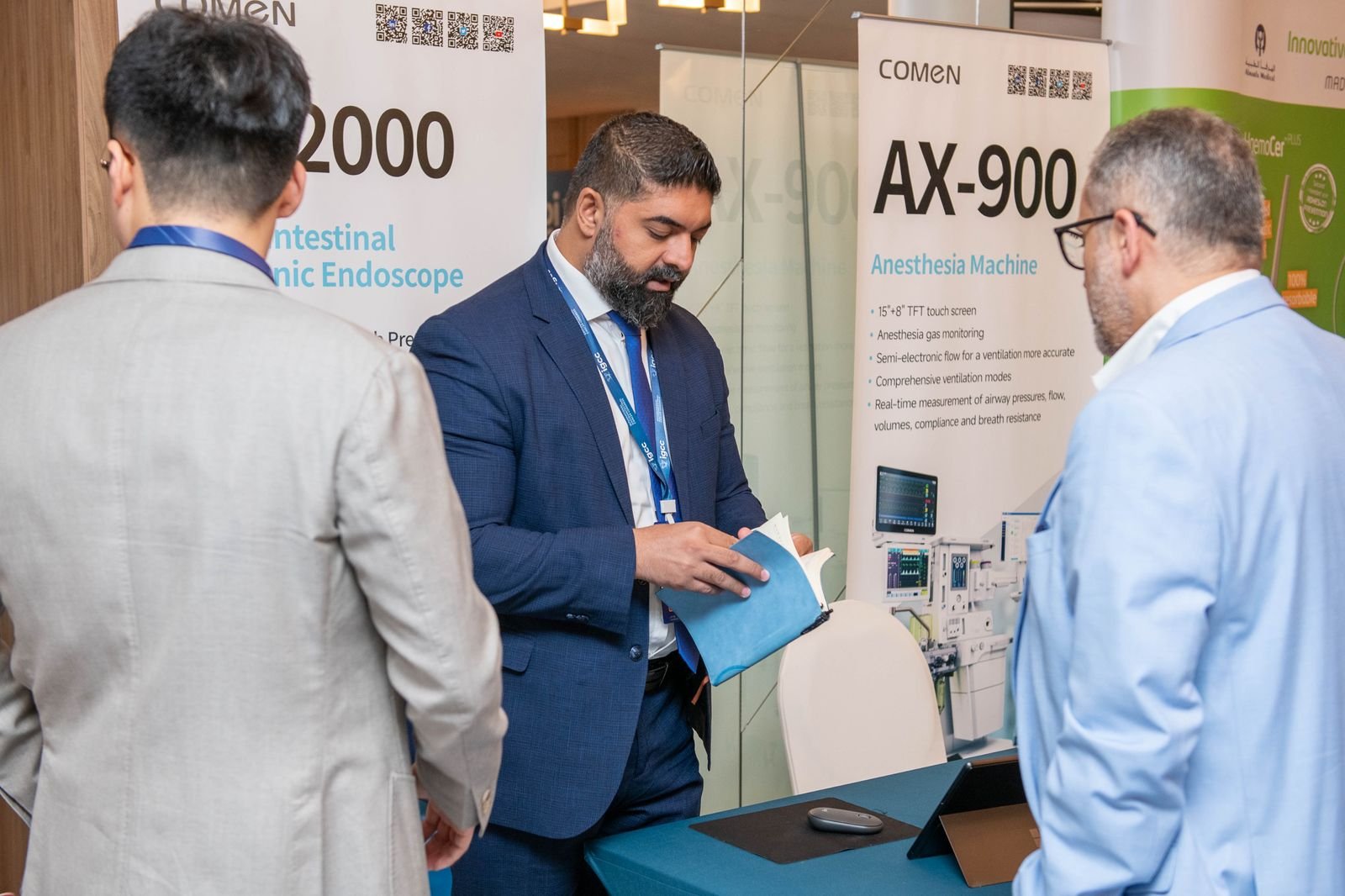 Delegates reviewing the COMEN exhibition booth